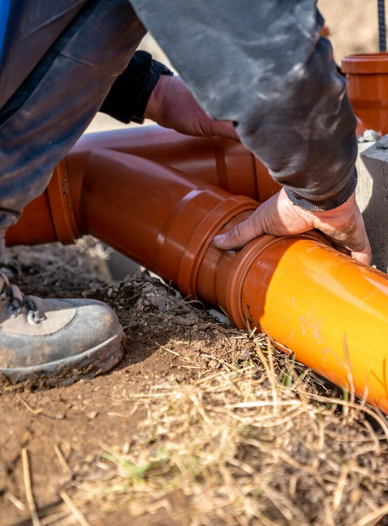 installation of a sewage plastic pipe during the construction of a house